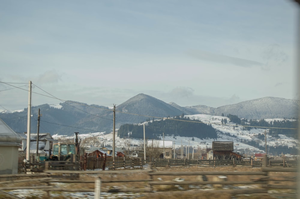 a view of a snowy mountain range from a train window