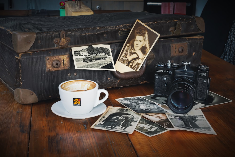 a coffee cup and a camera on a table