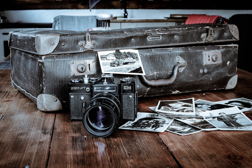 a camera and a suitcase sitting on a table