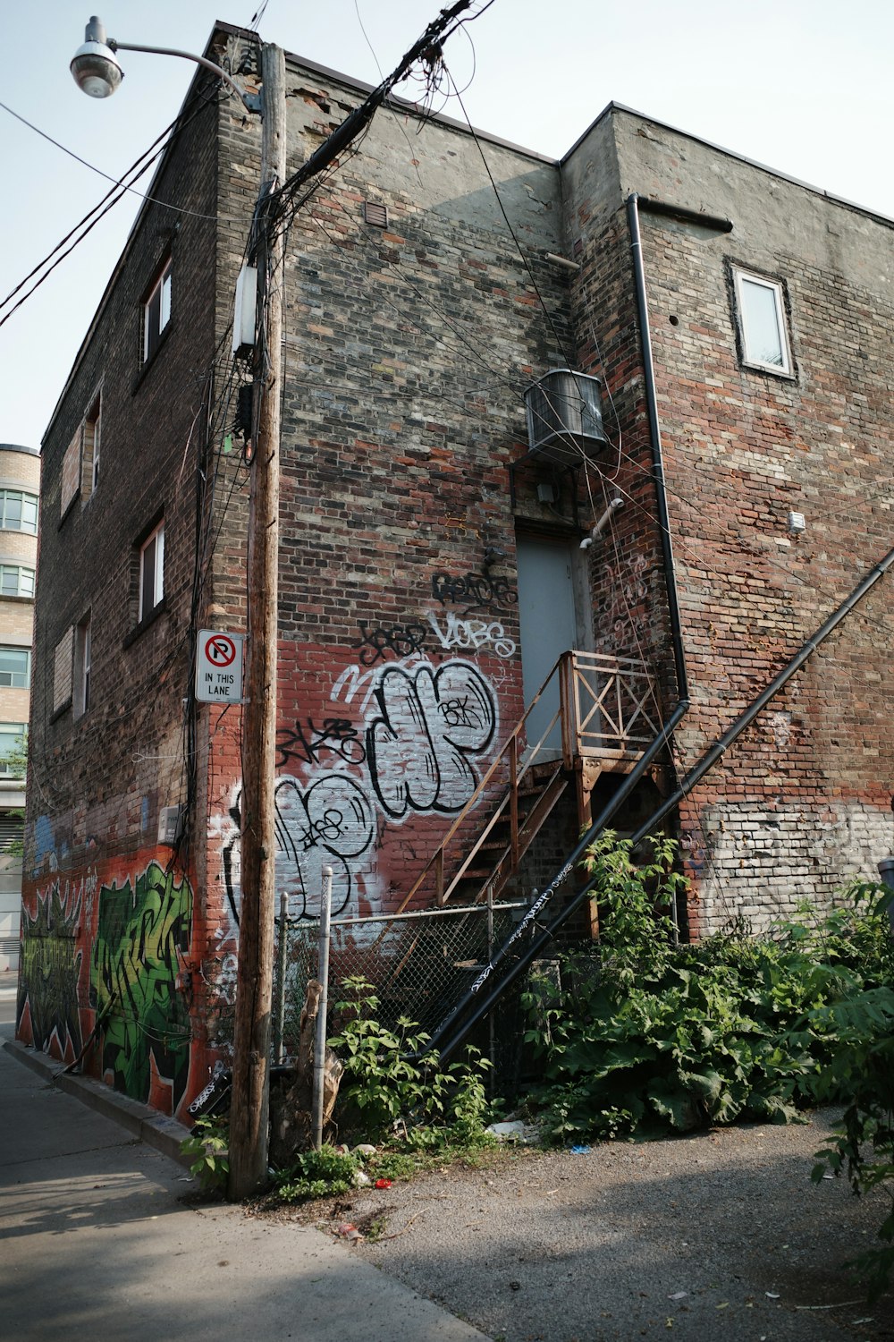 um prédio de tijolos com grafite ao lado