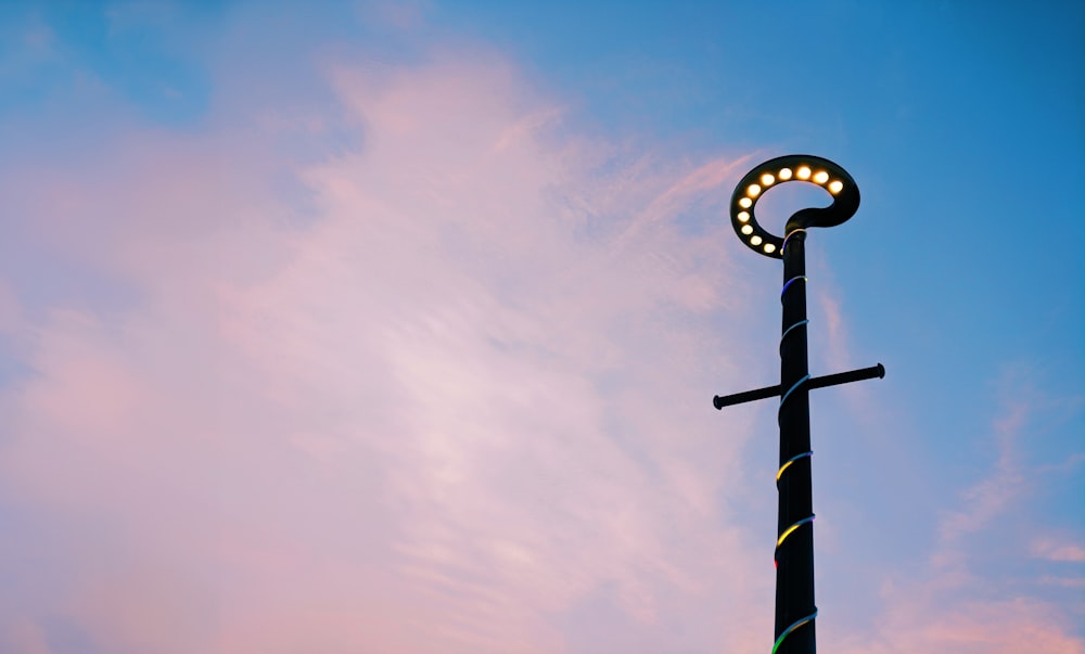 a street light with a cross on top of it