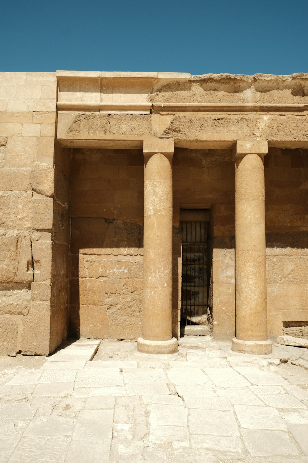 a stone building with columns and a door