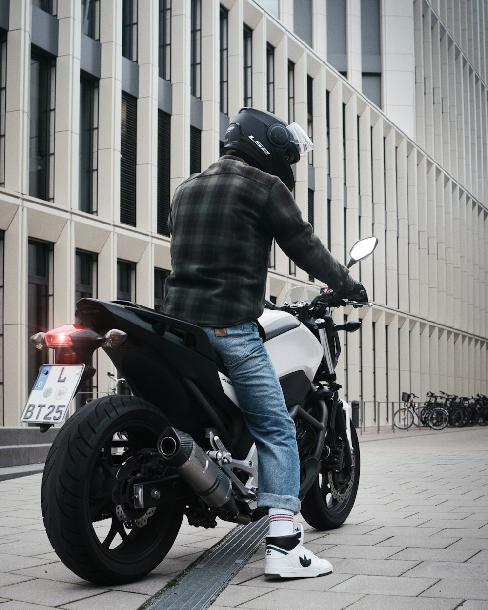 a man riding a motorcycle on a city street