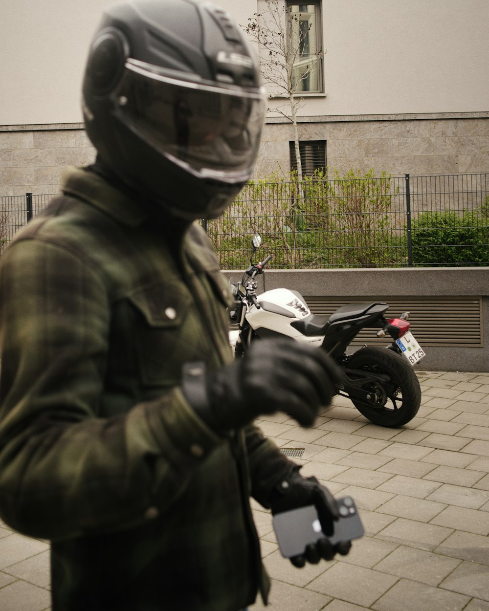 a man wearing a helmet and holding a cell phone