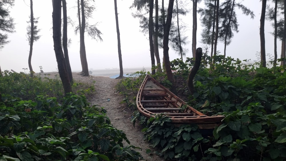 a row boat sitting on top of a dirt road