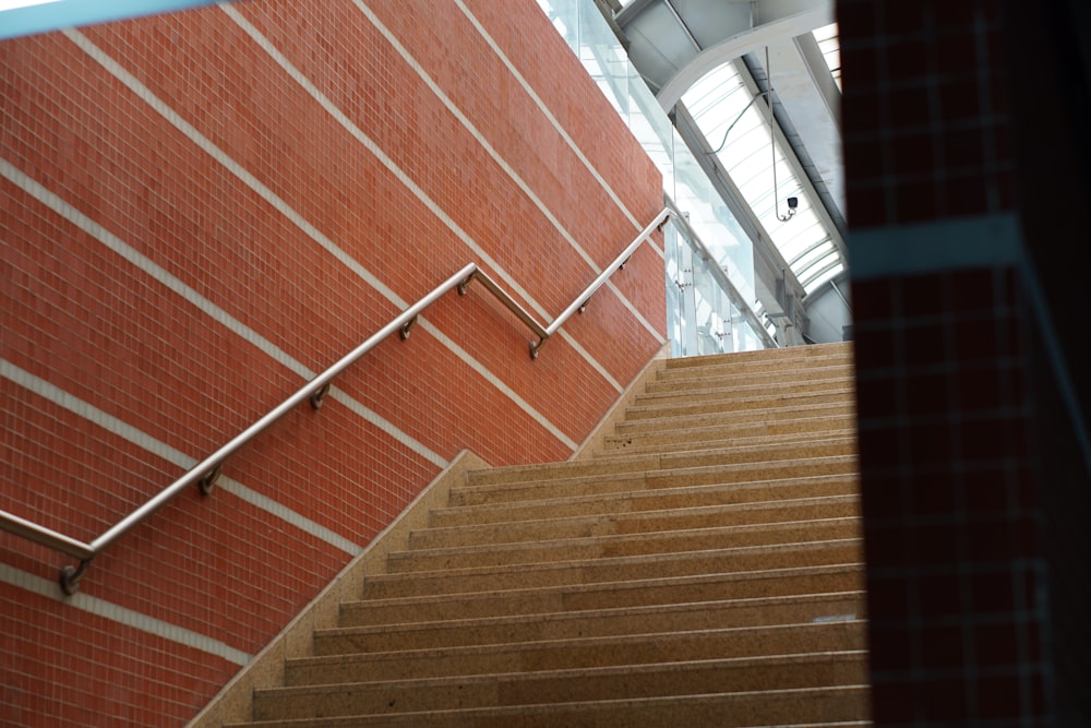 a set of stairs next to a red brick wall
