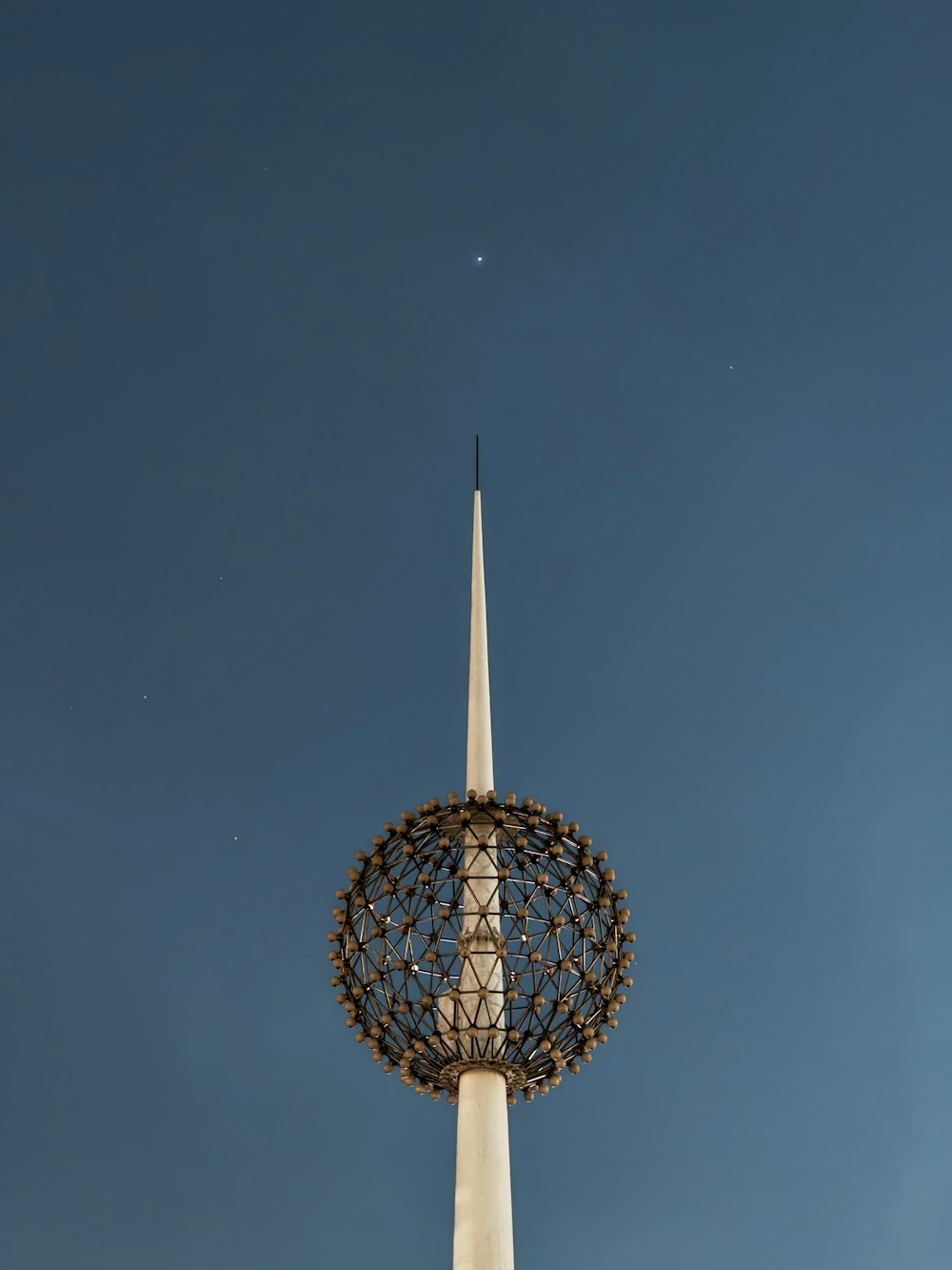 a tall white tower with a sky background