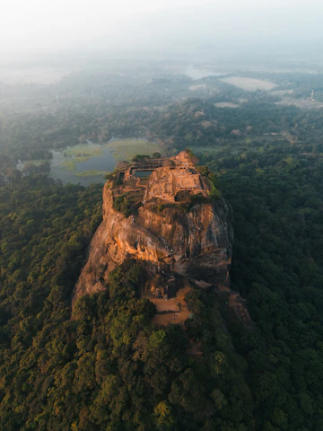 an aerial view of a rock formation in the middle of a forest