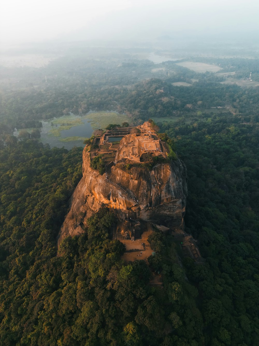 an aerial view of a rock formation in the middle of a forest