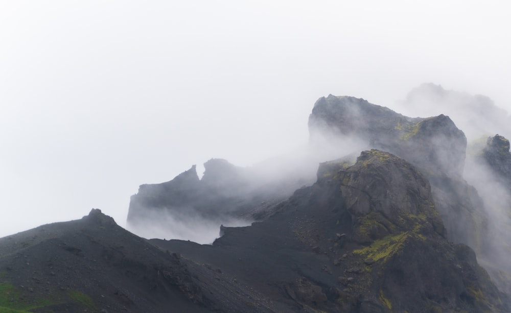 a very tall mountain covered in fog and clouds