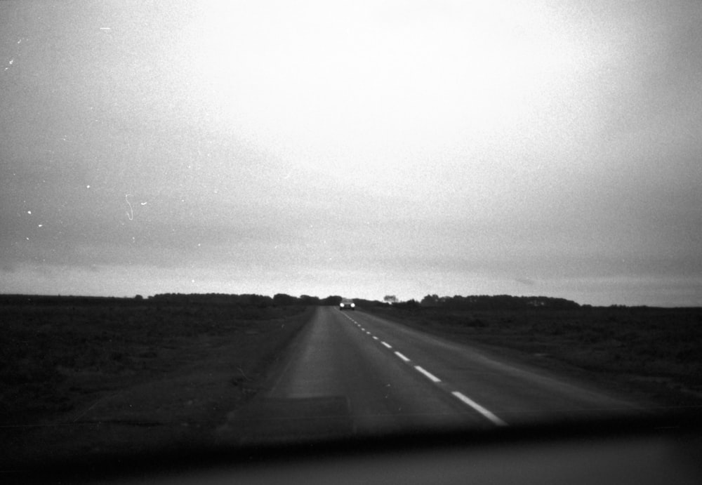 a black and white photo of a highway