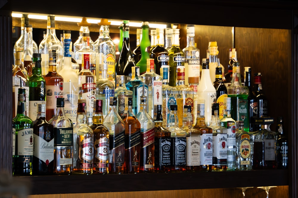 a wall full of bottles of alcohol in a bar