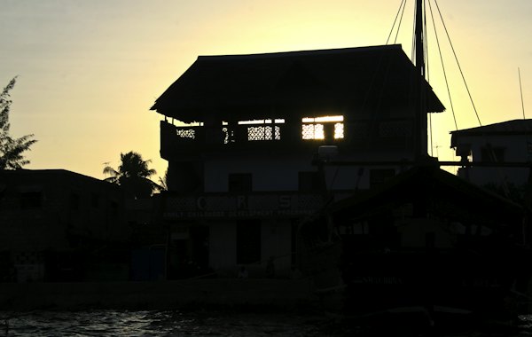 A rooftop silhouetted at dusk — Lamu, Kenya