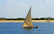 a sailboat with two people on it in the water