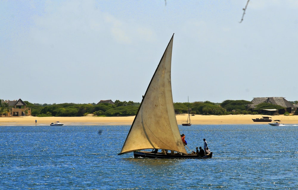 a sailboat with two people on it in the water