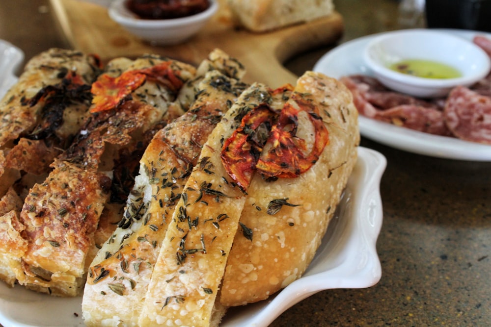 a white plate topped with bread covered in toppings