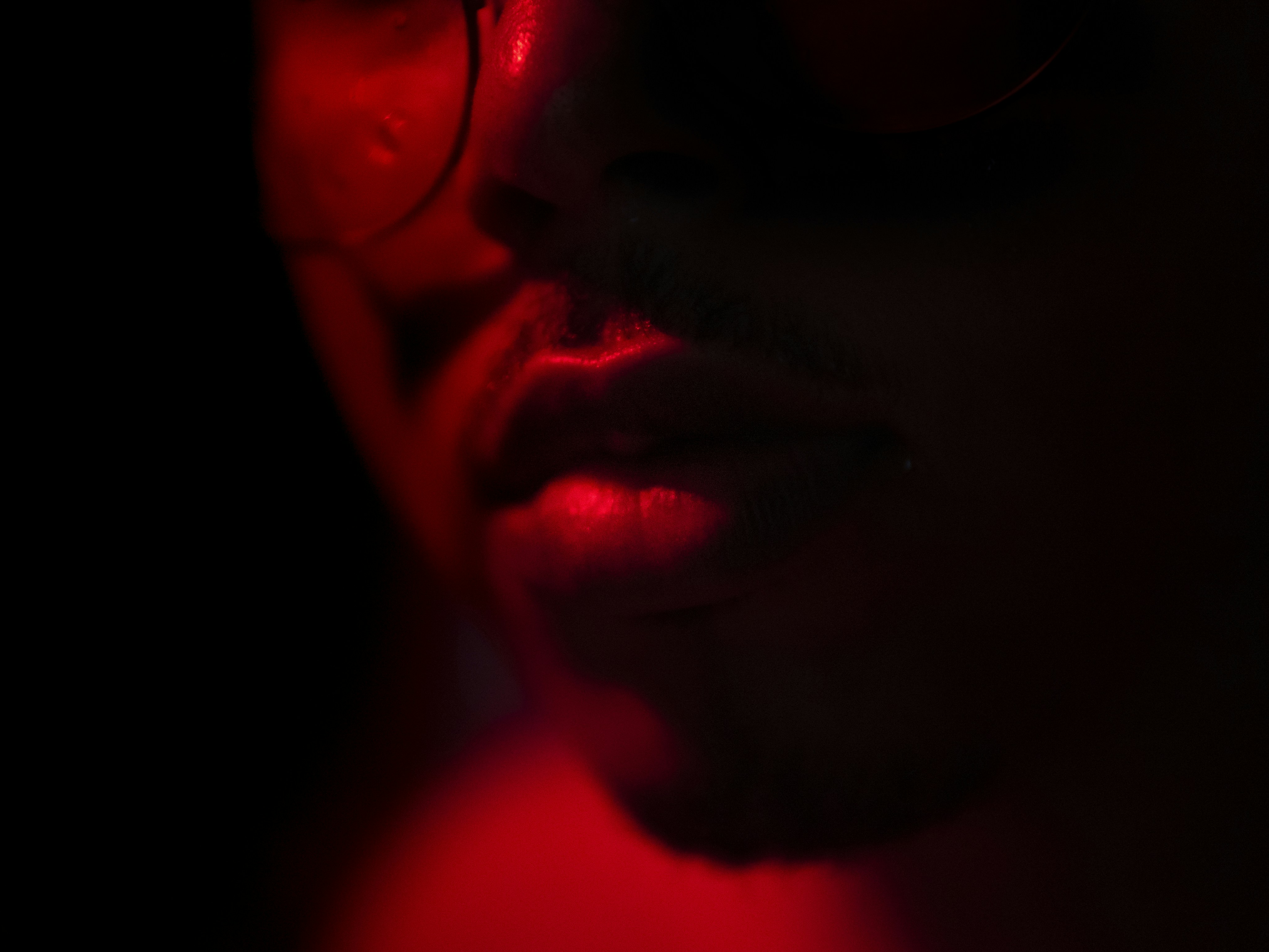 lips being illuminated by red neons