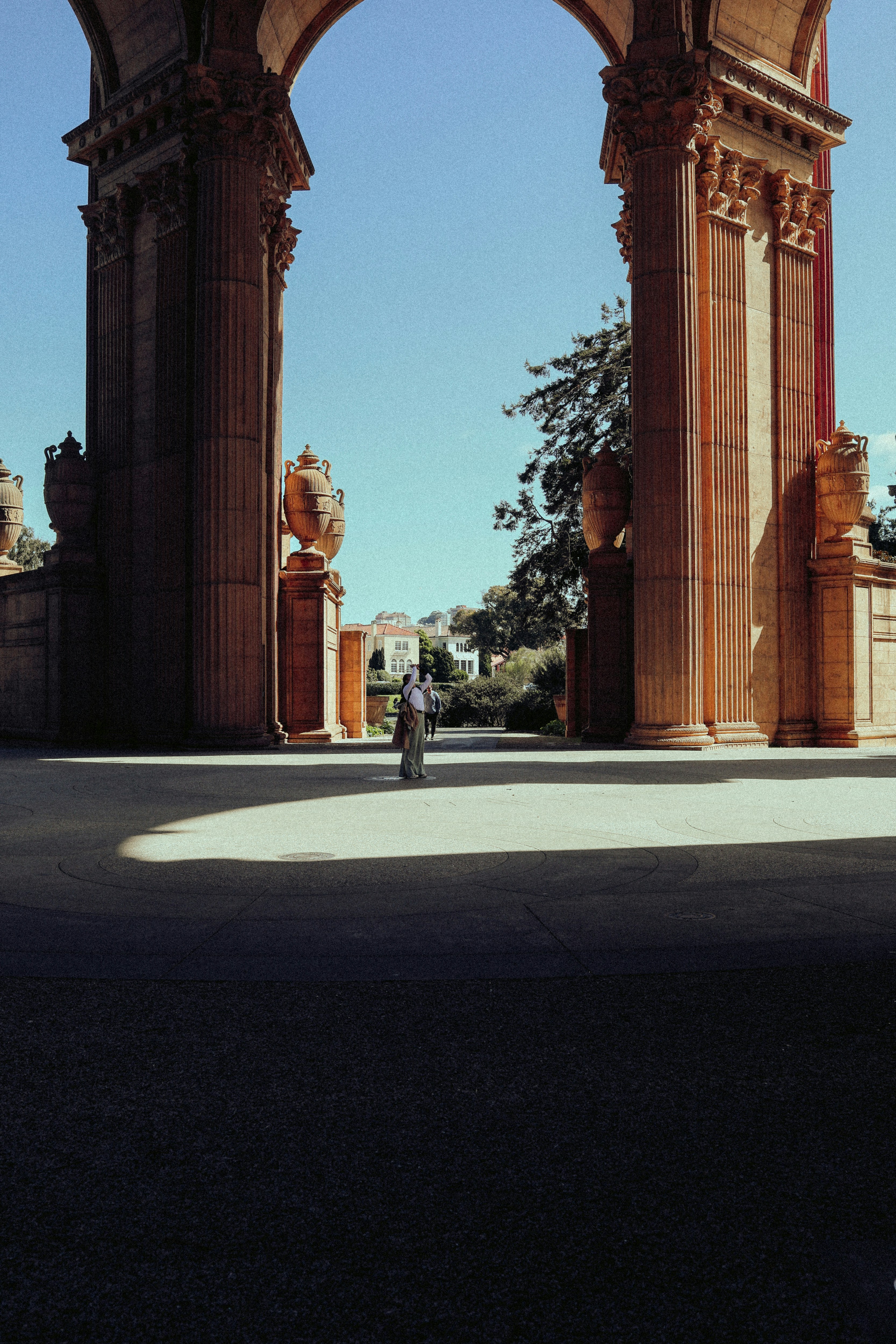 a person riding a bike under an arch