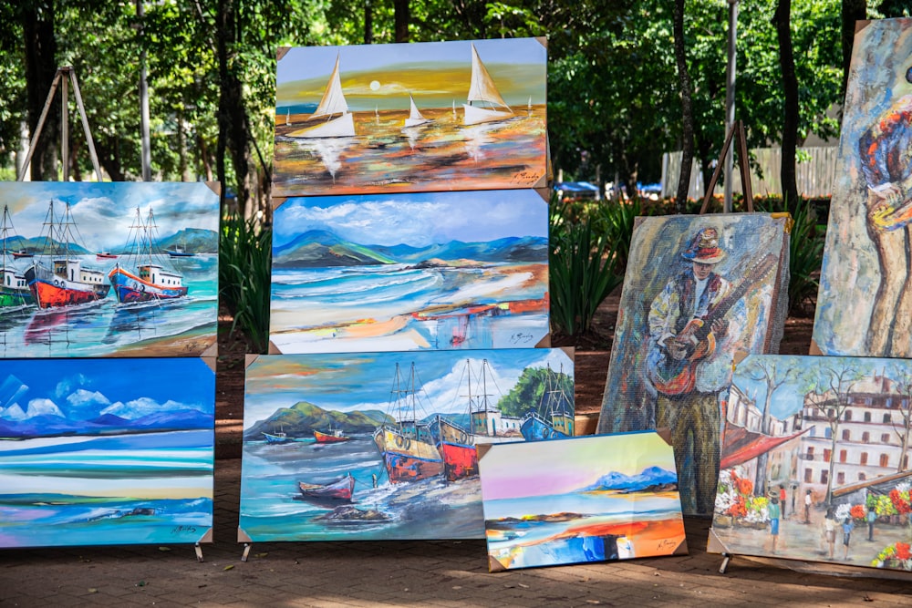 a bunch of paintings that are sitting on the ground