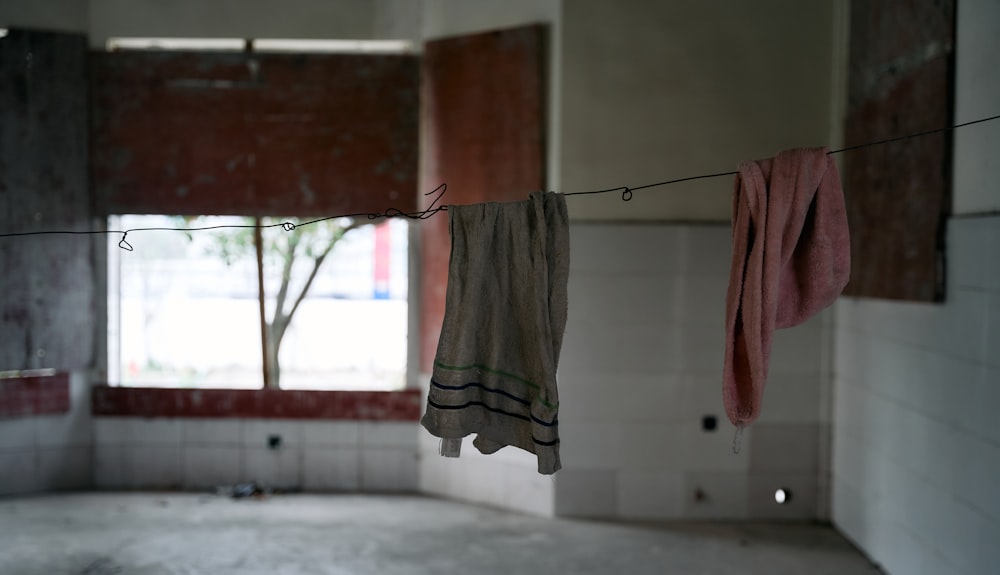 towels hanging on a clothes line in an empty room