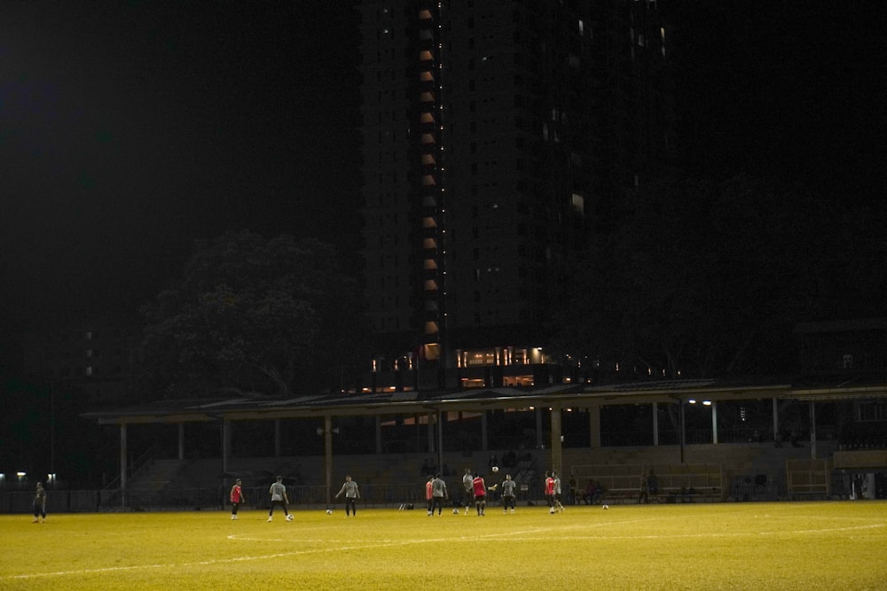 a group of people standing on top of a soccer field