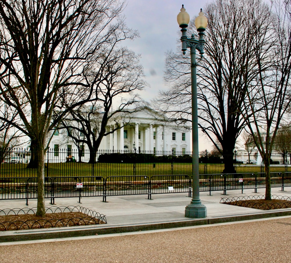 a street light in front of a white house