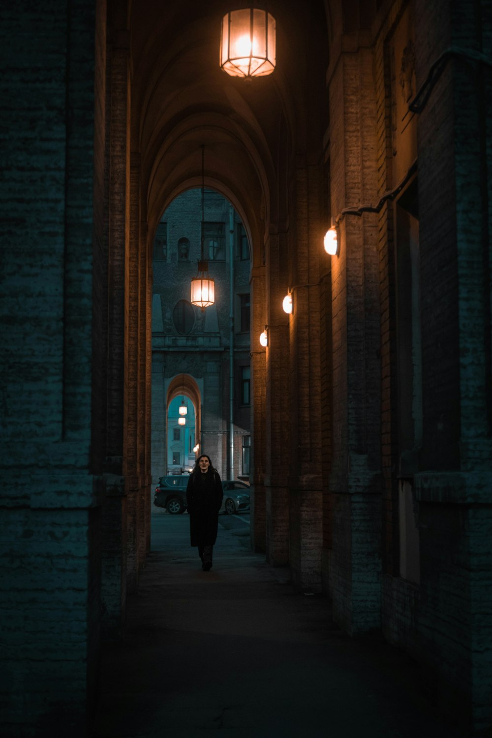 a person walking down a dark alley way