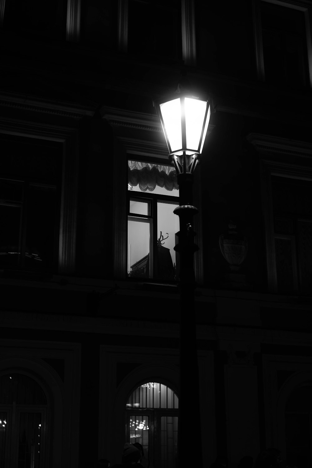 a black and white photo of a street light