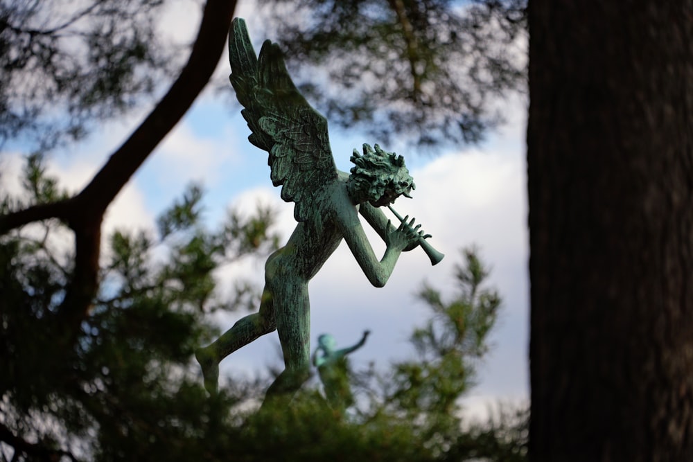 a statue of a mythical creature in a forest