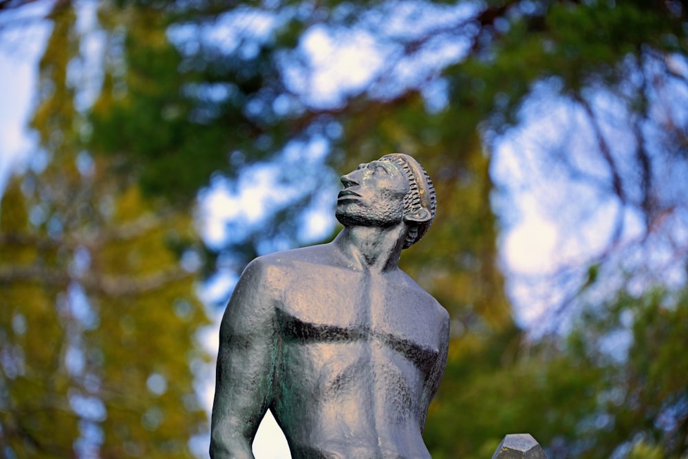 a statue of a man holding a bird in his hand