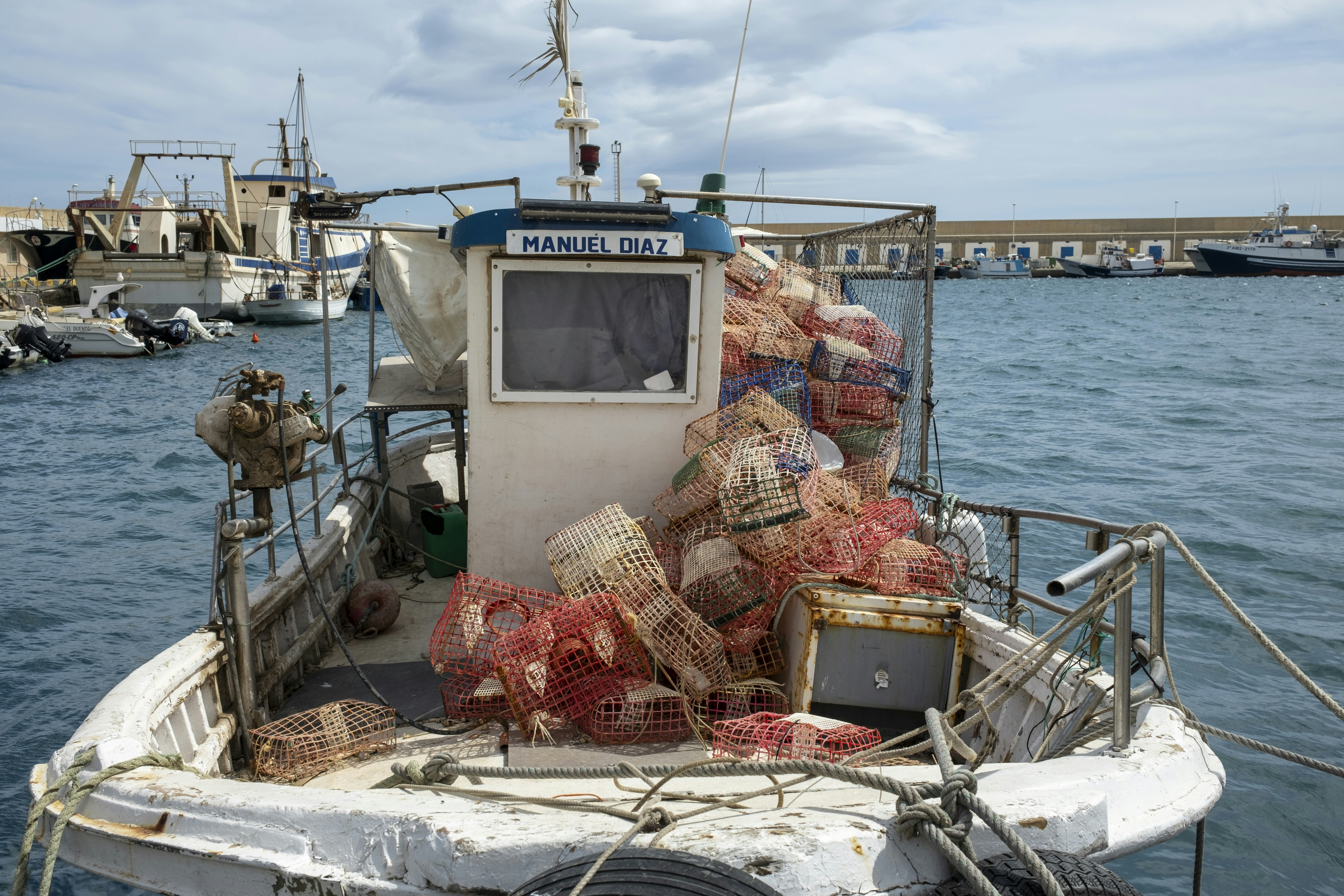 a fishing boat loaded with lobster traps in the water