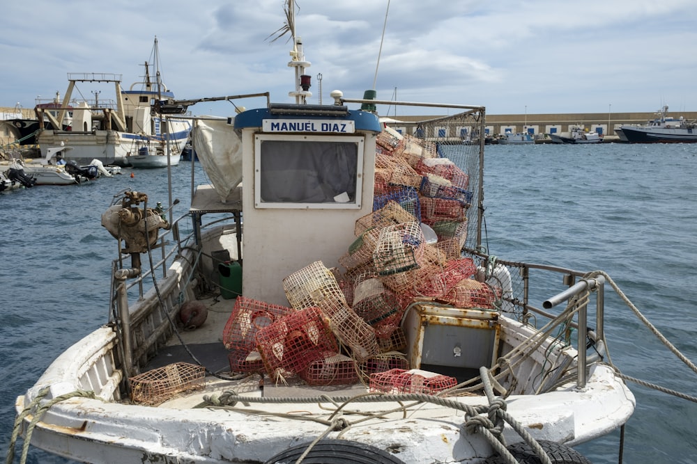 a fishing boat loaded with lobster traps in the water