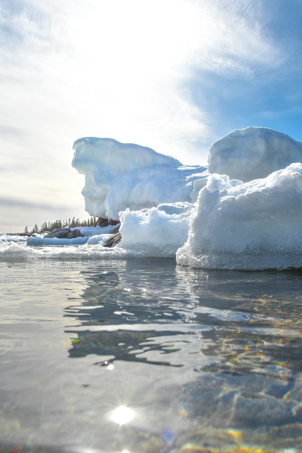 a group of icebergs floating on top of a body of water