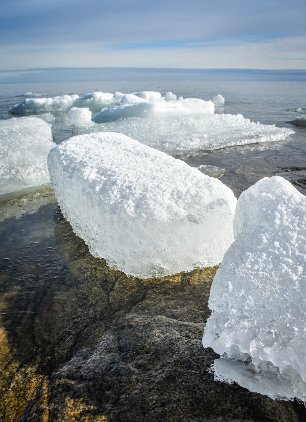 a group of icebergs floating on top of a body of water