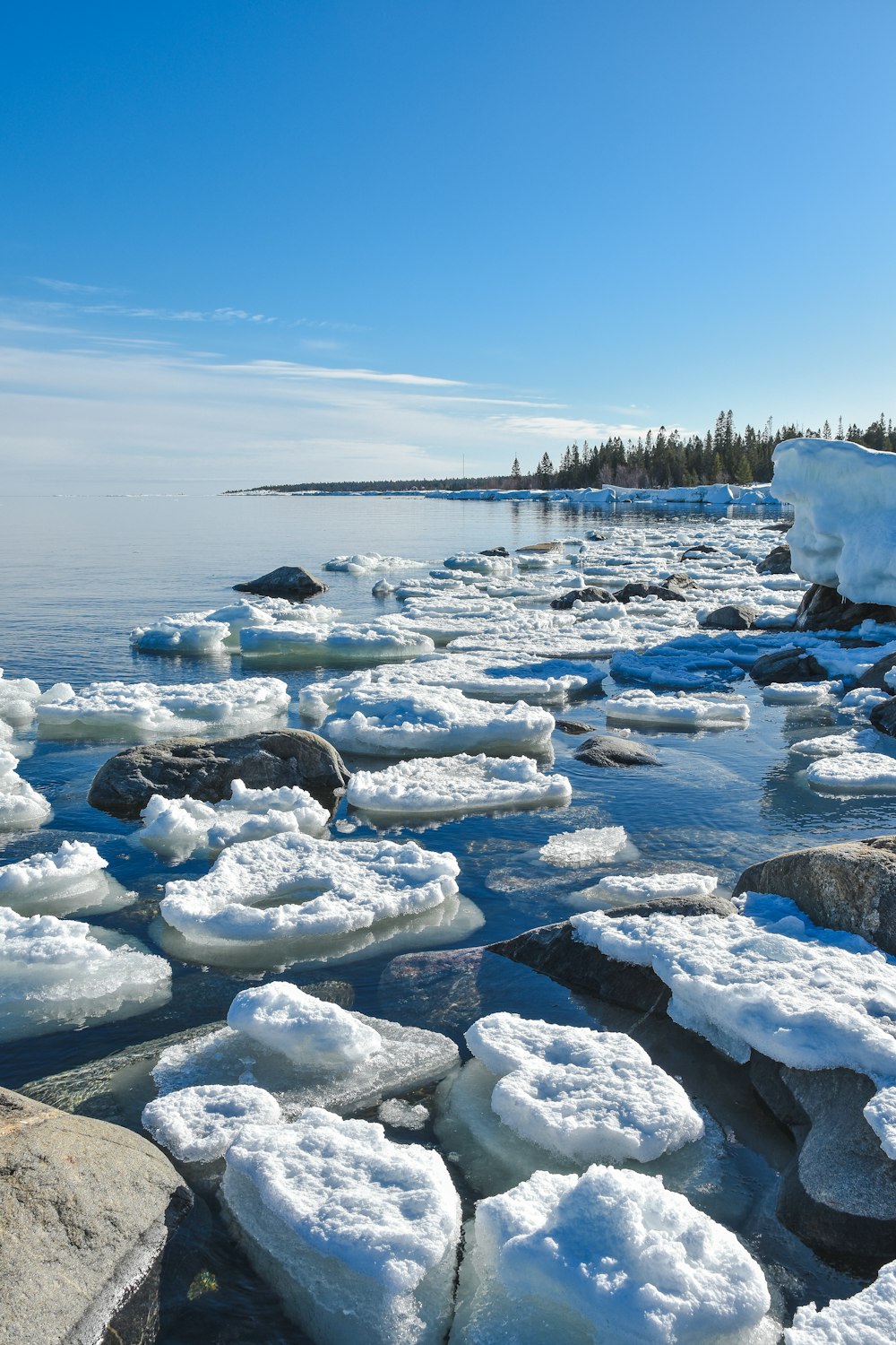 a group of ice blocks sitting on top of a body of water