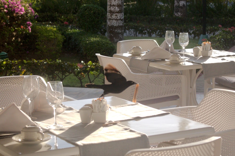 a restaurant with white tables and white chairs