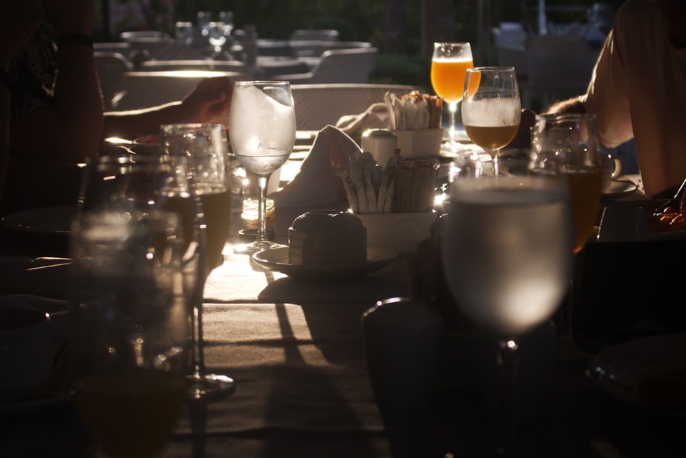 a group of people sitting at a table with glasses of beer