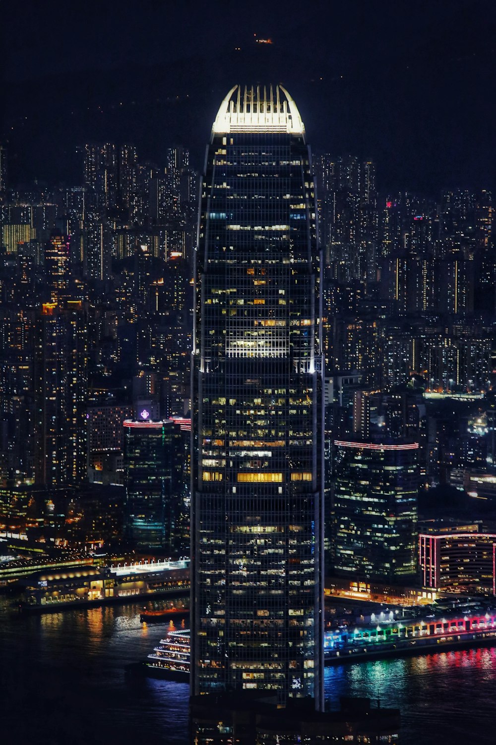 a very tall building in a big city at night