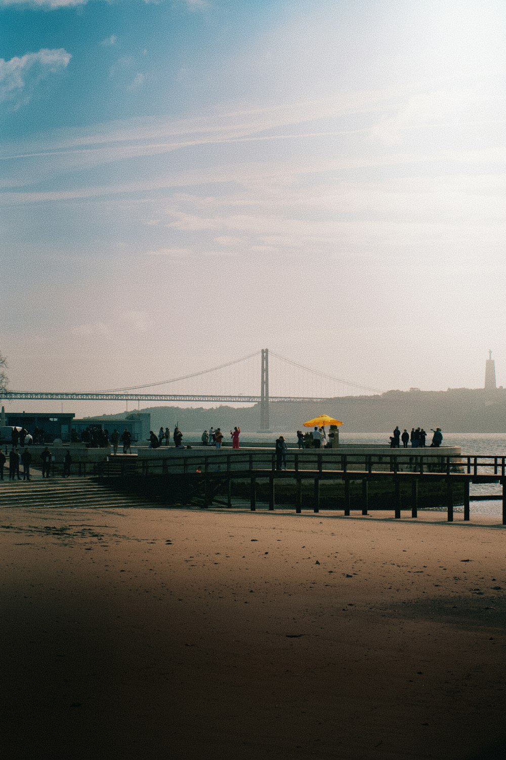 a group of people standing on top of a sandy beach