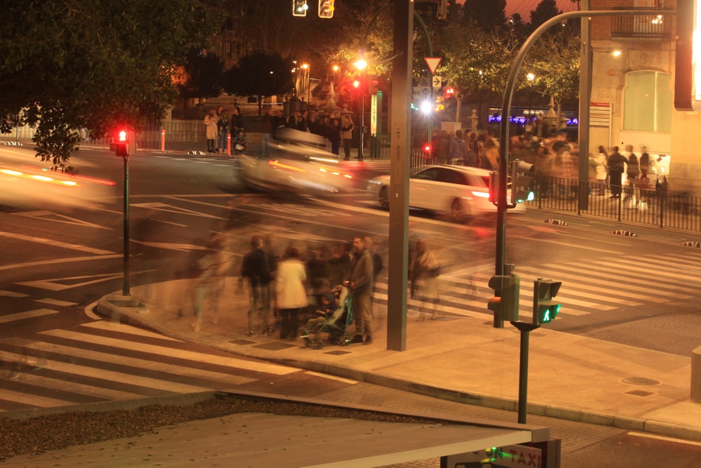 a group of people standing on the side of a road