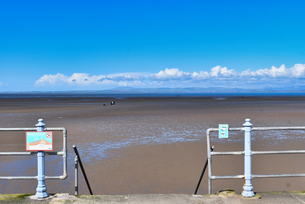 a couple of gates that are next to a beach