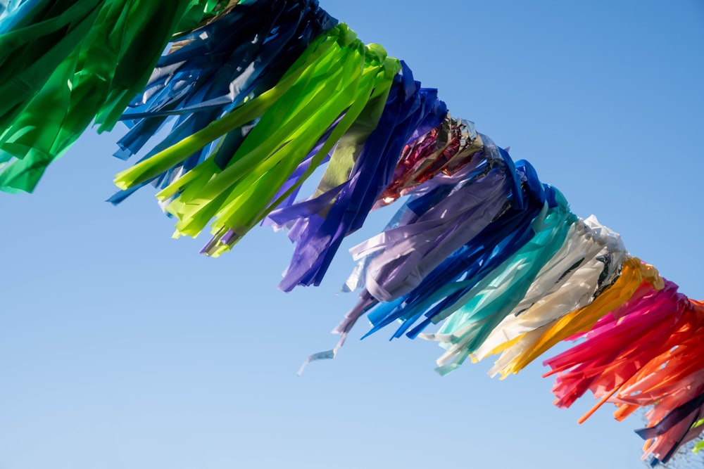 a bunch of colorful streamers hanging from a line