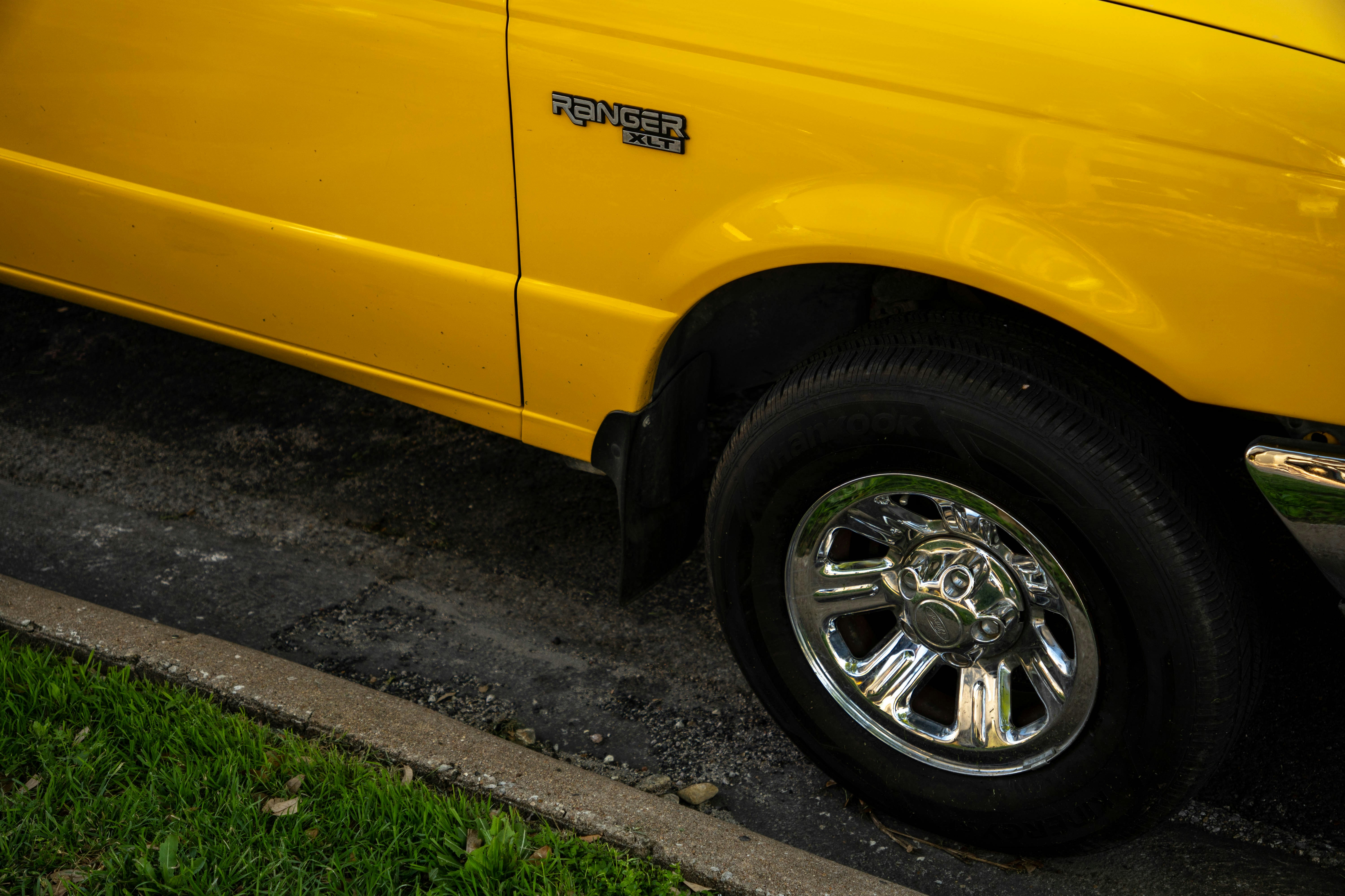 a yellow truck parked on the side of the road