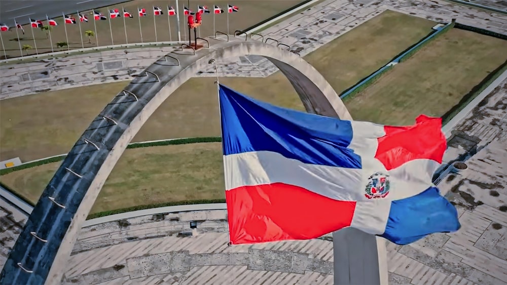 a flag flying in the air next to a bridge