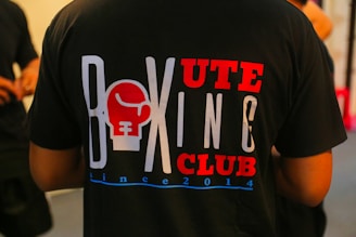 a man wearing a tshirt with a boxing club on it