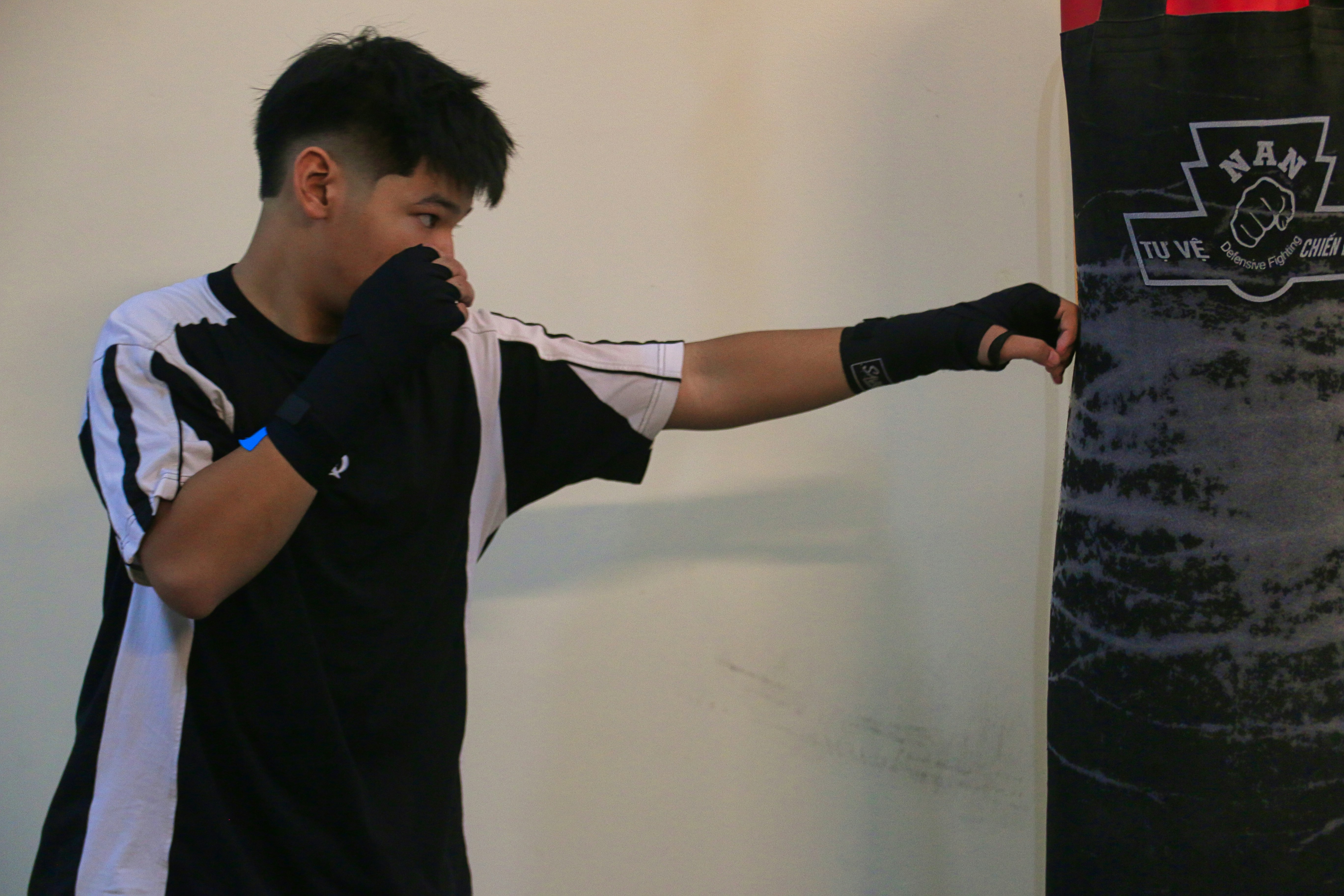 a young man is practicing his boxing moves