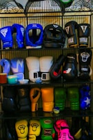 a rack filled with lots of different types of boxing gloves