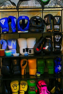a rack filled with lots of different types of boxing gloves