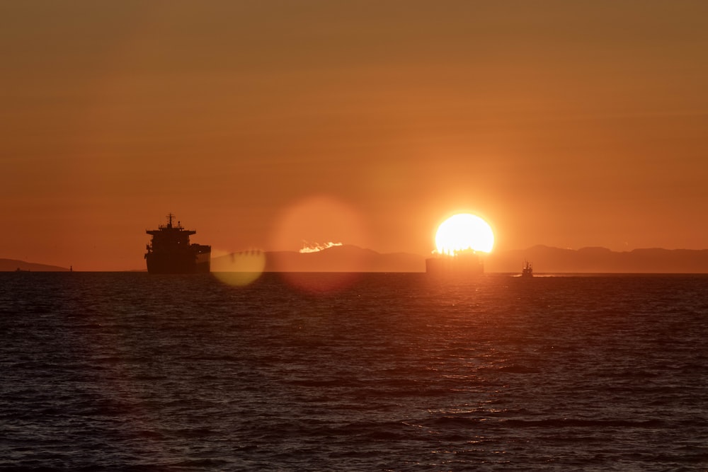 the sun is setting over a large body of water