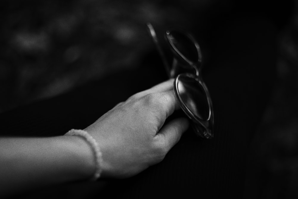 a pair of hands holding a pair of glasses